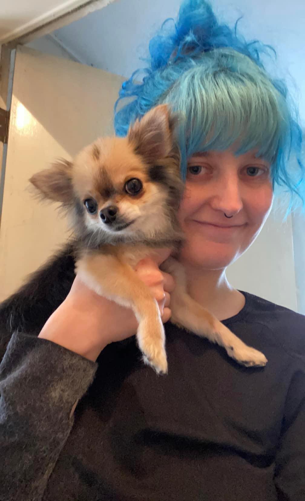 Girl holding small dog